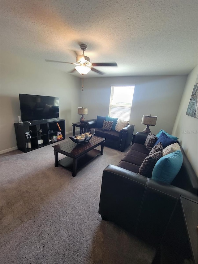 carpeted living room featuring ceiling fan and a textured ceiling