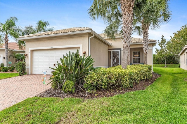 view of front of property with a front lawn and a garage