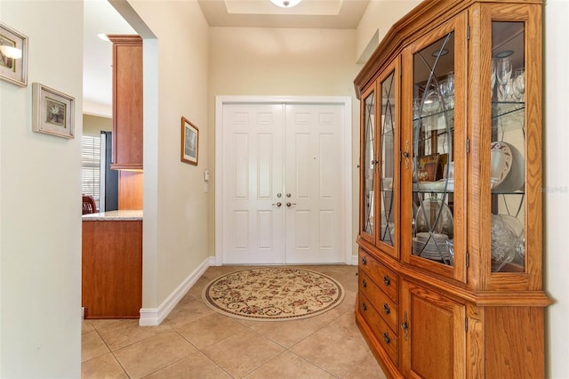 doorway with light tile patterned flooring