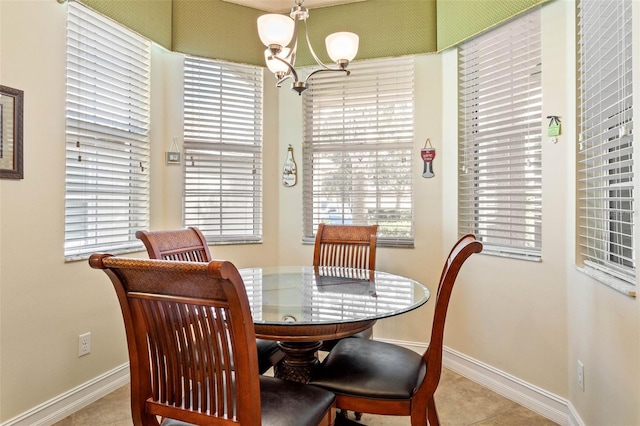 dining area featuring light tile patterned flooring and a notable chandelier