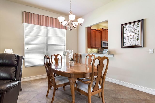 tiled dining space featuring an inviting chandelier