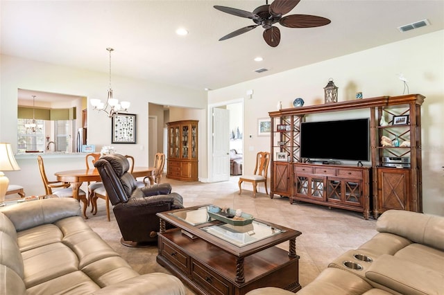 tiled living room featuring ceiling fan with notable chandelier