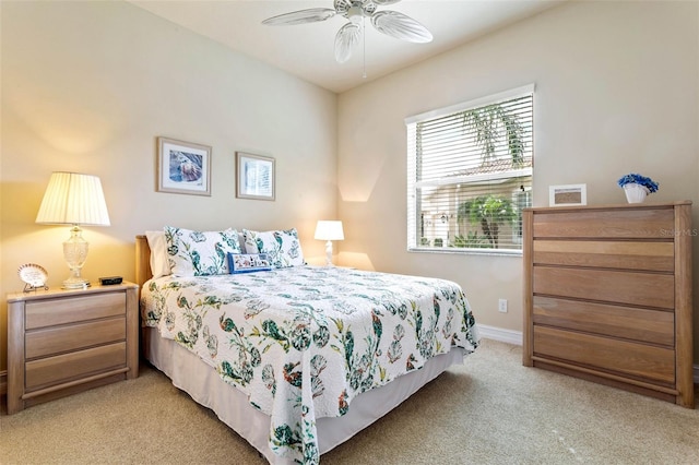 bedroom with ceiling fan and light colored carpet