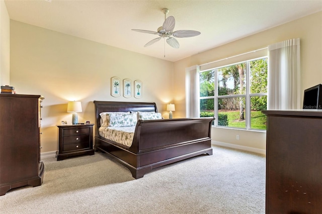 bedroom featuring light carpet and ceiling fan