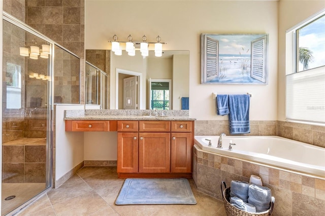 bathroom featuring independent shower and bath, vanity, and tile patterned floors