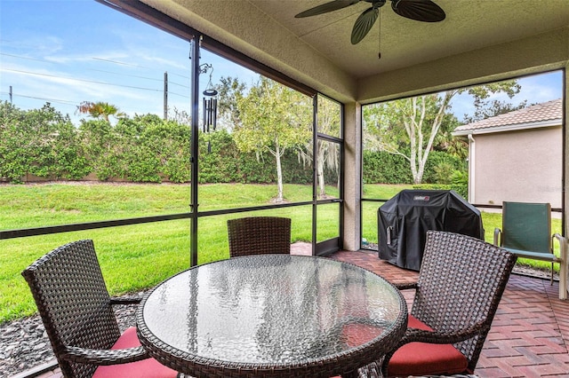 sunroom featuring ceiling fan