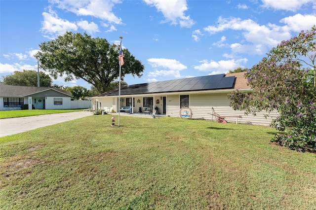 single story home with solar panels and a front yard