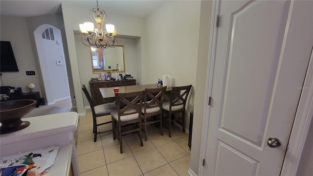 tiled dining space featuring a chandelier