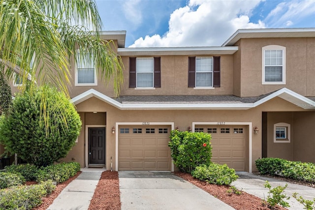 townhome / multi-family property featuring a garage