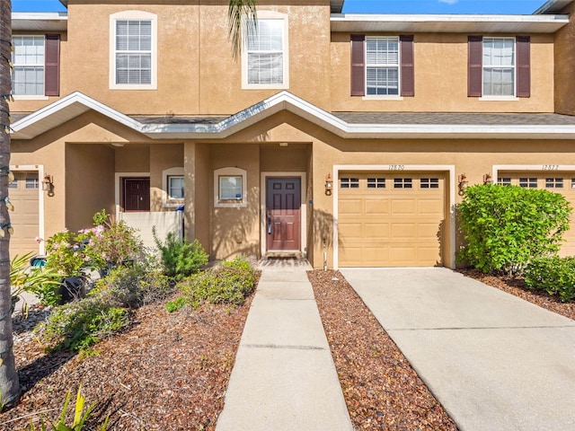 12820 Belvedere Song Way, Riverview, FL 33578 - view of property featuring stucco siding, a garage, and concrete driveway