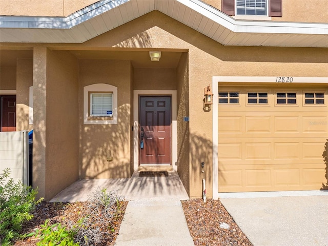 12820 Belvedere Song Way, Riverview, FL 33578 - doorway to property featuring stucco siding and a garage
