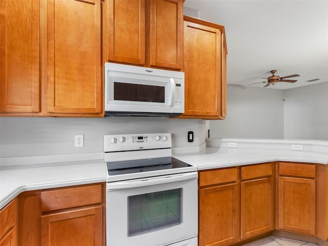 12820 Belvedere Song Way, Riverview, FL 33578 - kitchen featuring white appliances, light countertops, ceiling fan, a peninsula, and brown cabinets