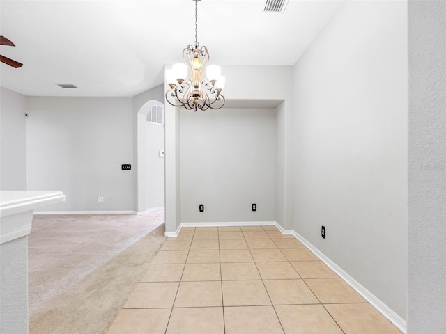 12820 Belvedere Song Way, Riverview, FL 33578 - empty room featuring arched walkways, a chandelier, a ceiling fan, and light tile patterned floors
