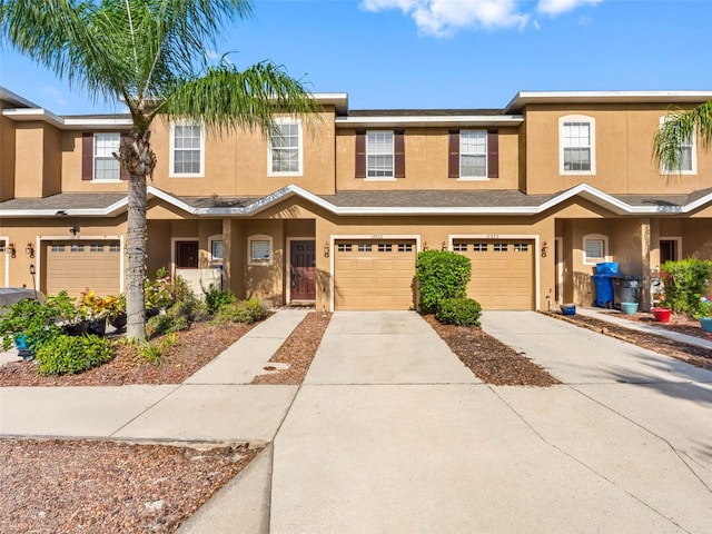 12820 Belvedere Song Way, Riverview, FL 33578 - townhome / multi-family property with stucco siding, concrete driveway, and a garage