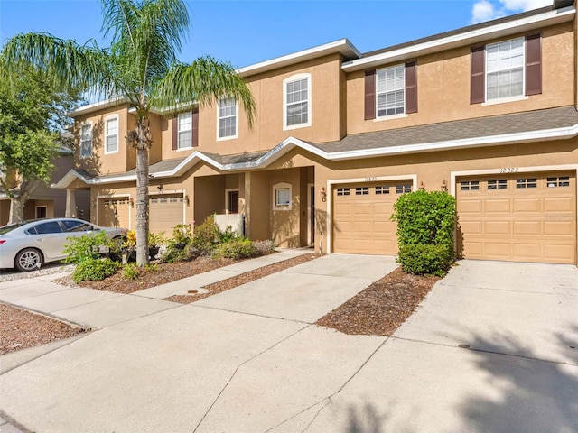 12820 Belvedere Song Way, Riverview, FL 33578 - view of property featuring stucco siding, a garage, and driveway