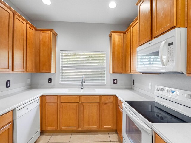 12820 Belvedere Song Way, Riverview, FL 33578 - kitchen with white appliances, plenty of natural light, recessed lighting, light countertops, and light tile patterned floors