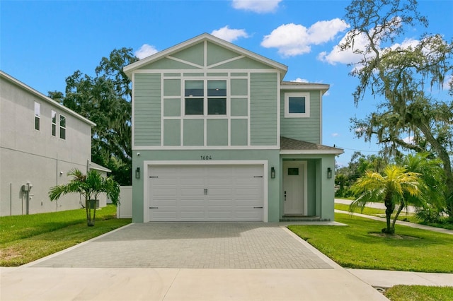 view of front of home featuring a garage and a front lawn