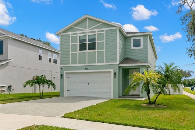 view of front of house featuring a garage and a front lawn