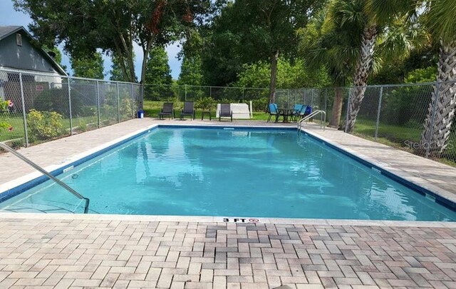 view of swimming pool featuring a patio area