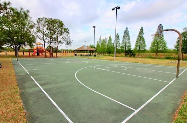 view of basketball court featuring a playground and a gazebo