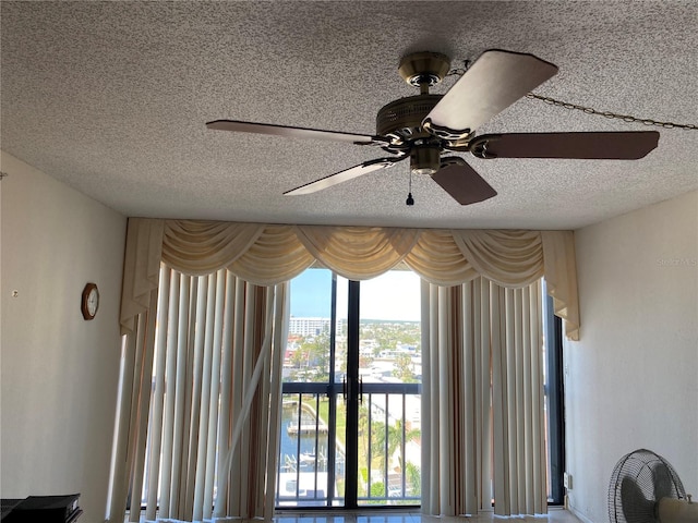 details featuring ceiling fan and a textured ceiling