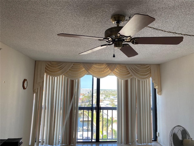 interior details featuring a textured ceiling and a ceiling fan