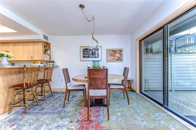 dining area featuring a textured ceiling