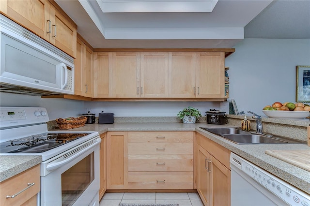 kitchen featuring light brown cabinetry, light tile patterned floors, sink, and white appliances