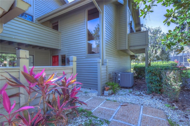 view of side of home featuring a balcony and cooling unit