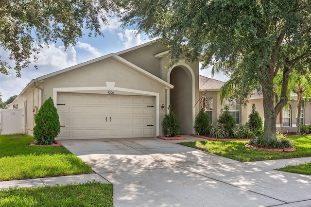 view of front of house featuring a garage and a front lawn