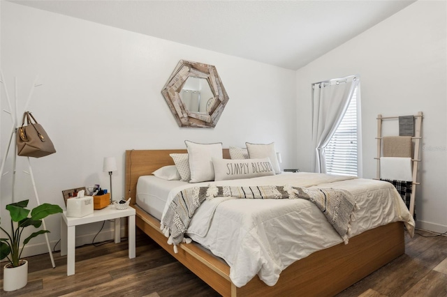 bedroom featuring lofted ceiling and dark hardwood / wood-style flooring