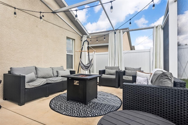 view of patio / terrace with an outdoor living space with a fire pit