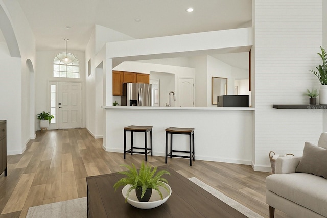4206 Branchside Ln, Wesley Chapel, FL 33543 - foyer with light wood finished floors, arched walkways, lofted ceiling, and recessed lighting