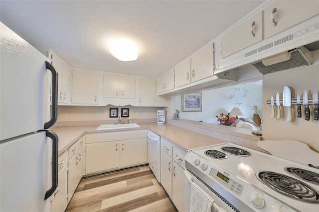 kitchen with light wood-type flooring, white appliances, and white cabinetry