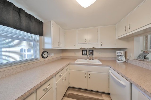 kitchen with dishwasher, light hardwood / wood-style flooring, sink, and white cabinetry