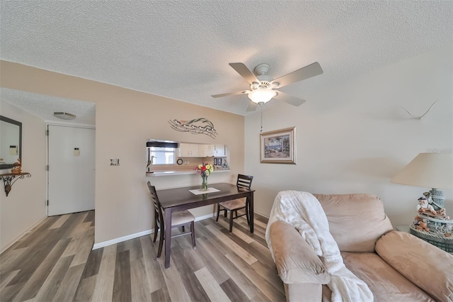 office featuring ceiling fan, a textured ceiling, hardwood / wood-style floors, and sink