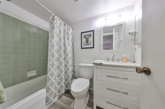 full bathroom featuring shower / bathtub combination with curtain, hardwood / wood-style flooring, vanity, and toilet