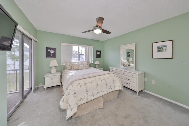 carpeted bedroom featuring ceiling fan, a textured ceiling, and access to exterior