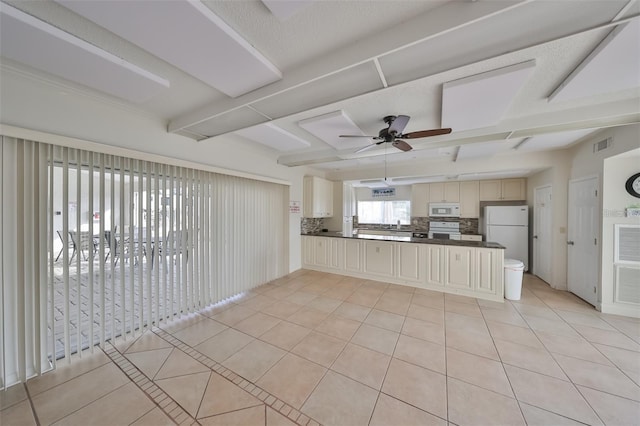 kitchen featuring light tile patterned flooring, backsplash, and white appliances