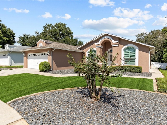 ranch-style house featuring a front yard and a garage