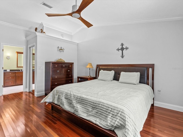 bedroom featuring ornamental molding, dark hardwood / wood-style floors, ceiling fan, and ensuite bath