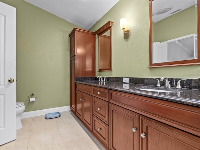 bathroom with vanity, tile patterned flooring, and toilet