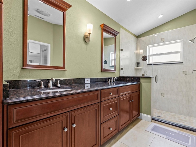 bathroom with lofted ceiling, tile patterned flooring, an enclosed shower, and vanity