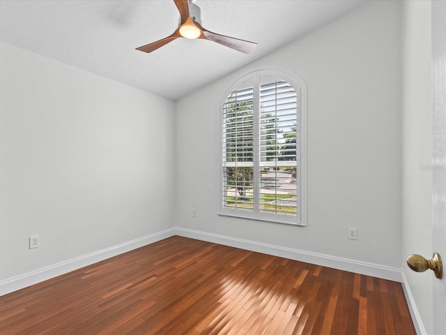 unfurnished room with a textured ceiling, ceiling fan, and dark wood-type flooring