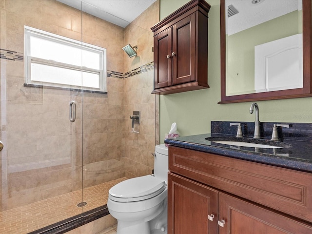 bathroom featuring a textured ceiling, an enclosed shower, vanity, and toilet