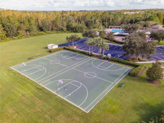 view of basketball court with a lawn