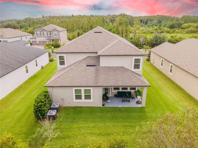 exterior space with a patio, central AC, and a lawn