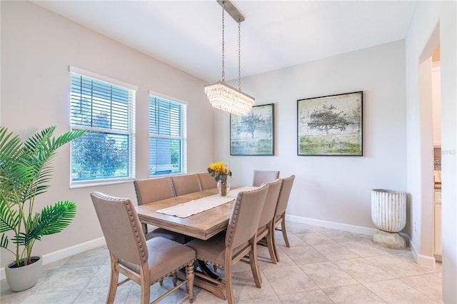 dining room with an inviting chandelier and light tile patterned floors