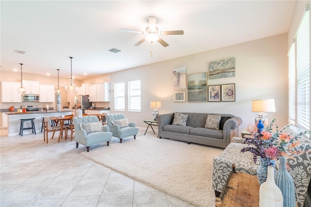 tiled living room featuring ceiling fan