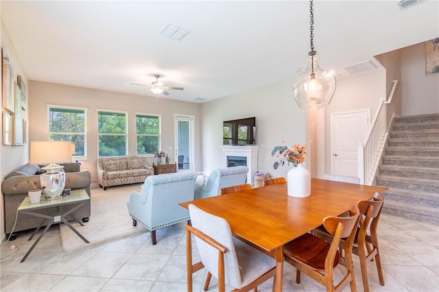 tiled dining area featuring ceiling fan